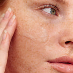 Model using INIKA Organic Phytofuse Renew Exfoliator on her skin