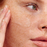Model using INIKA Organic Phytofuse Renew Exfoliator on her skin