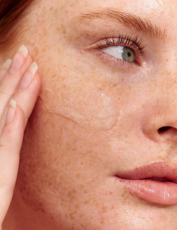 Model using INIKA Organic Phytofuse Renew Exfoliator on her skin