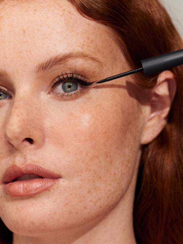 Model wearing INIKA Organic Liquid Eyeliner in Black