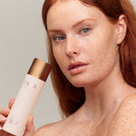 Model cleansing her face with INIKA Organic Phyto-Active Rosewater Micellar