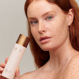 Model cleansing her face with INIKA Organic Phyto-Active Rosewater Micellar