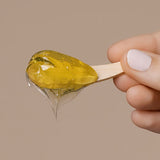 Close-up of Mukti Deep Cleanse Enzyme Mask gel on a wooden spatula