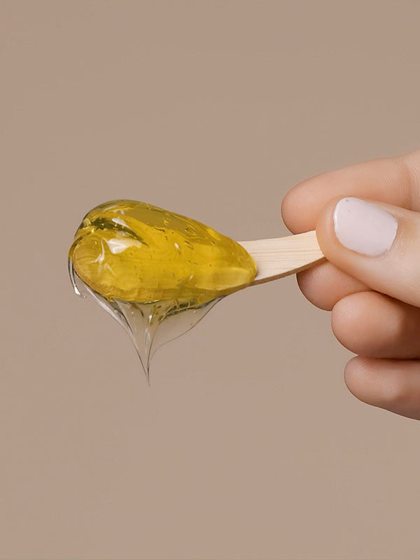 Close-up of Mukti Deep Cleanse Enzyme Mask gel on a wooden spatula