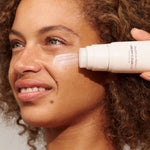 Model using INIKA Organic Phytofuse Renew Cream Cleanser in her skincare routine