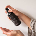 Hands pumping Mukti Balancing Cleansing Gel into an open palm