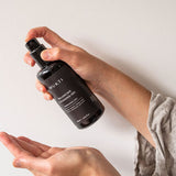Hands pumping Mukti Balancing Cleansing Gel into an open palm