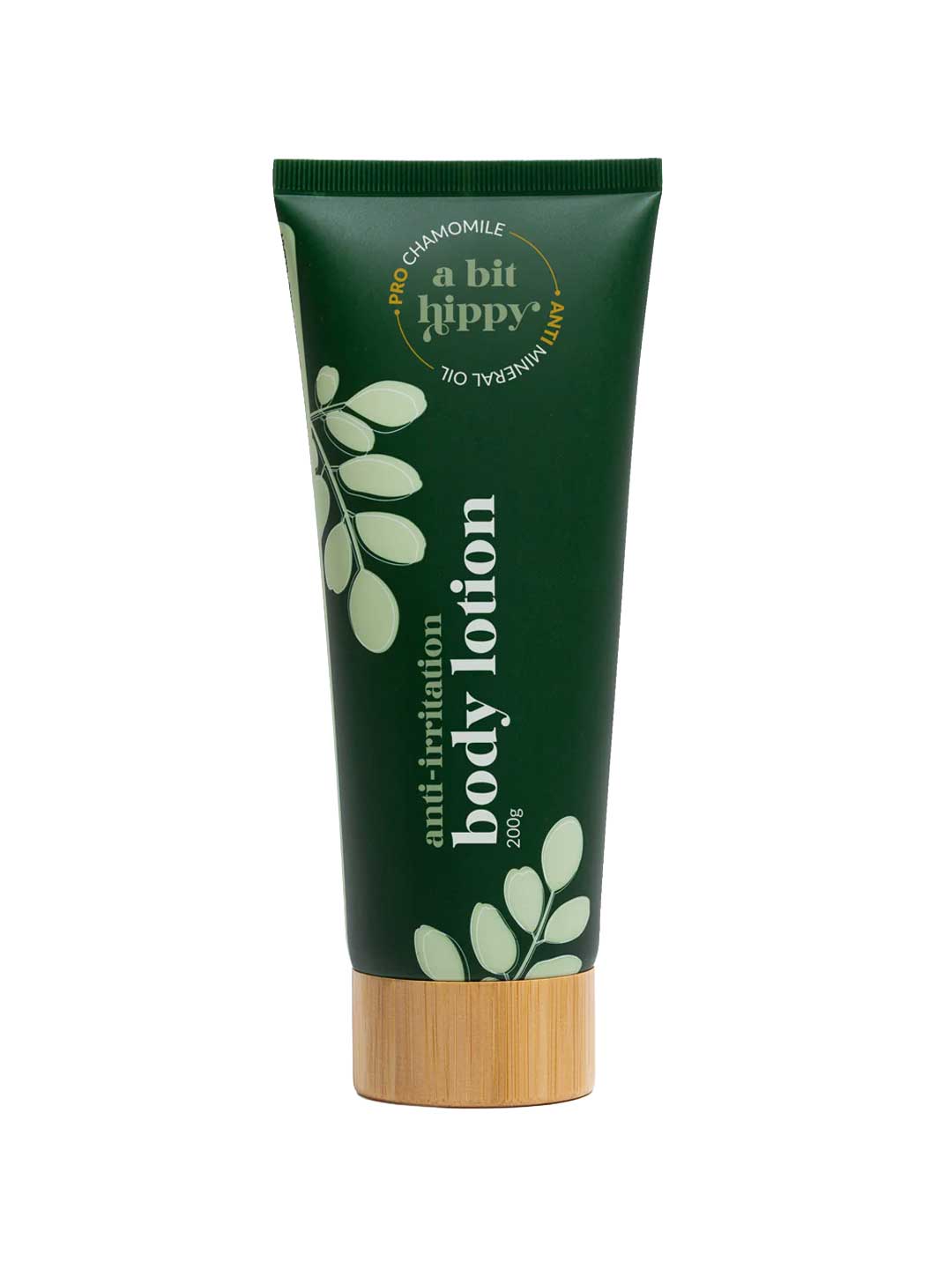 A Bit Hippy Body Lotion 200g comes in a dark green tube with white foliage graphics and a wooden cap, formulated with chamomile, hyaluronic acid, and mineral oil—ideal for sensitive skin.