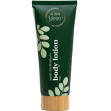 A Bit Hippy Body Lotion 200g comes in a dark green tube with white foliage graphics and a wooden cap, formulated with chamomile, hyaluronic acid, and mineral oil—ideal for sensitive skin.
