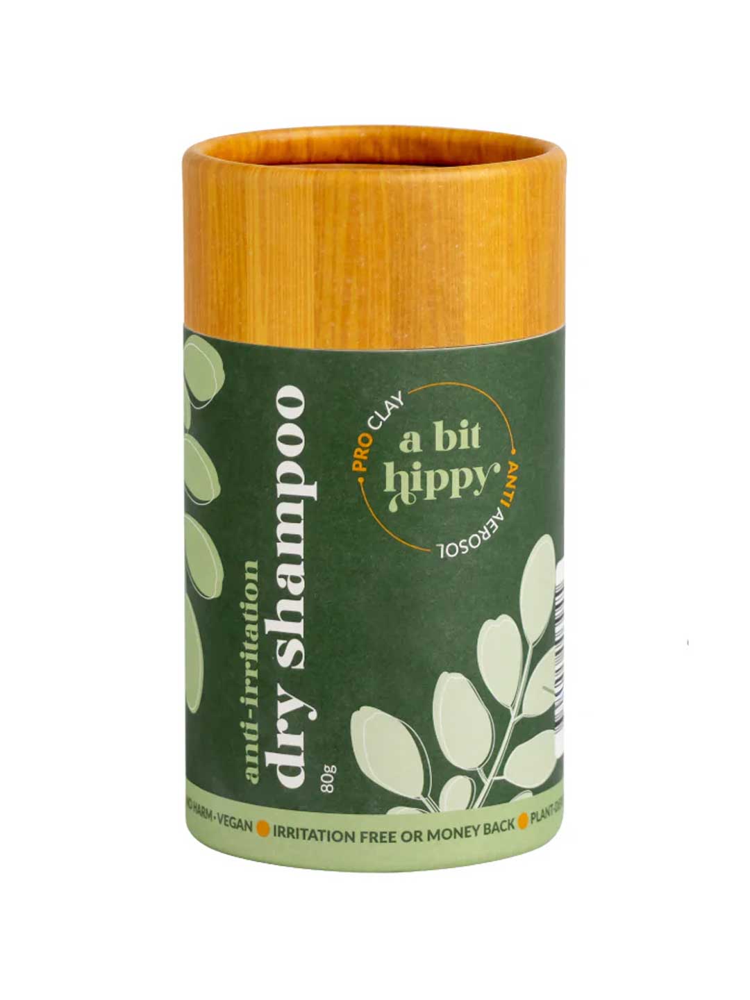 A Bit Hippy Dry Shampoo 80g comes in a cylindrical container with a wooden lid and green label with white leafy graphics, featuring Australian Olive Clay and arnica as key ingredients.