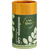 A Bit Hippy Dry Shampoo 80g comes in a cylindrical container with a wooden lid and green label with white leafy graphics, featuring Australian Olive Clay and arnica as key ingredients.