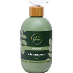Green shampoo bottle with bamboo cap on a white background
