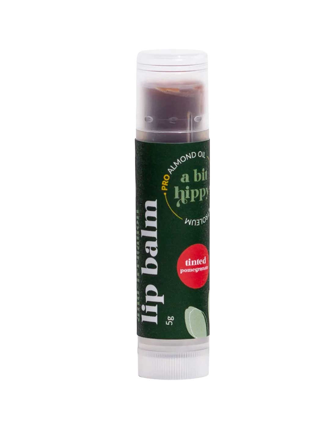 A Bit Hippy Tinted Pomegranate Lip Balm 5g features a dark green label, white cap, almond oil, and a petroleum-free formula from A Bit Hippy.