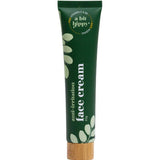 A Bit Hippy Face Cream 65g comes in a green tube with a wooden cap, white text, and leafy designs. This natural moisturiser contains Vitamin C, B5, and hyaluronic acid for anti-irritation benefits.