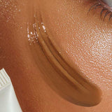 Close-up of a person’s cheek with Avocado Zinc SPF 50 Natural Tinted Moisturiser (Medium-Dark) applied, showing smooth, even coverage and dewy skin. "Medium-Dark" is labeled at the bottom.
