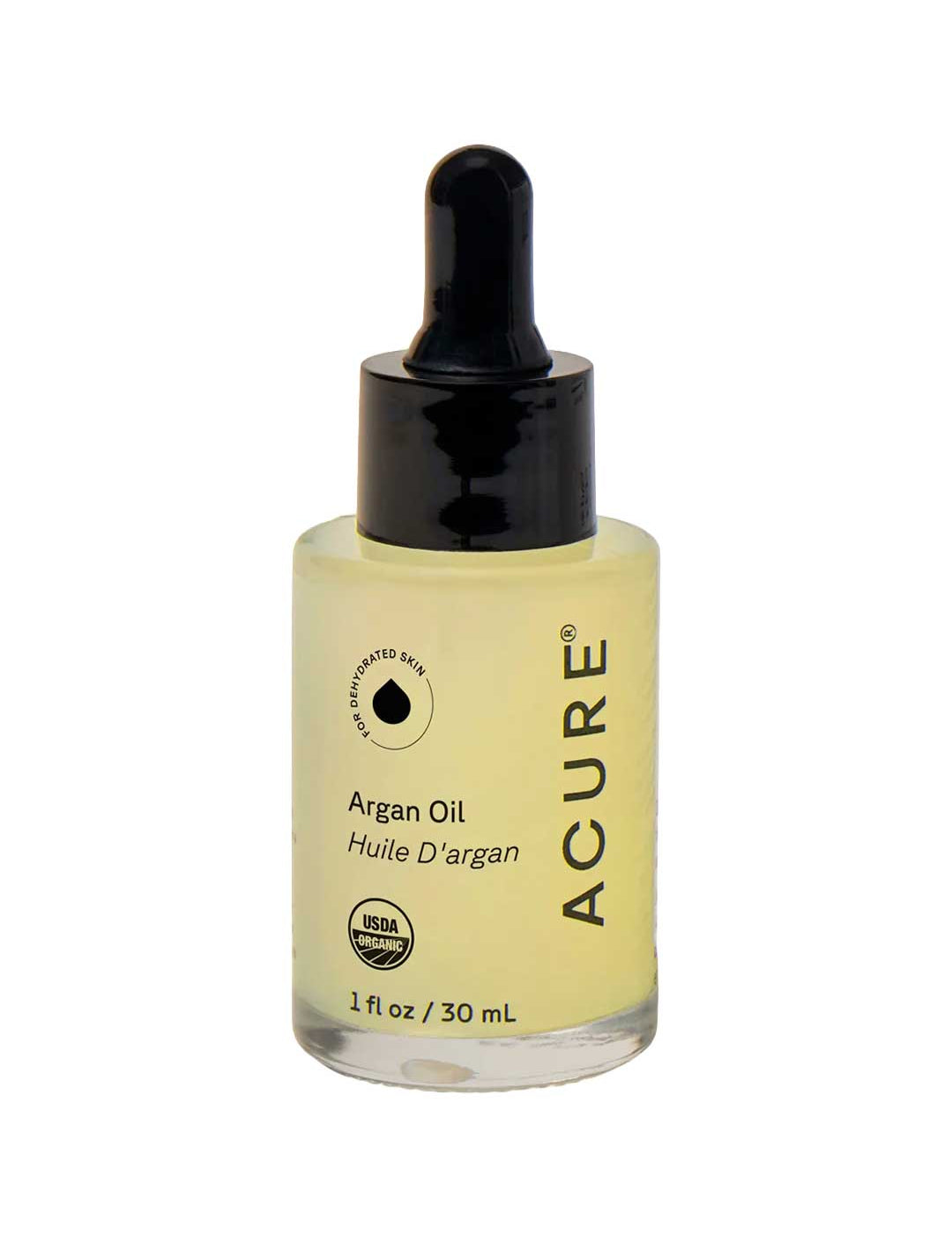 A bottle of Acure Argan Oil with a black dropper cap and a clear glass bottle showing the pale yellow oil inside, set against a plain white background.
