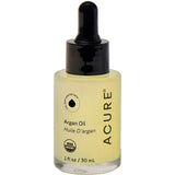 A bottle of Acure Argan Oil with a black dropper cap and a clear glass bottle showing the pale yellow oil inside, set against a plain white background.
