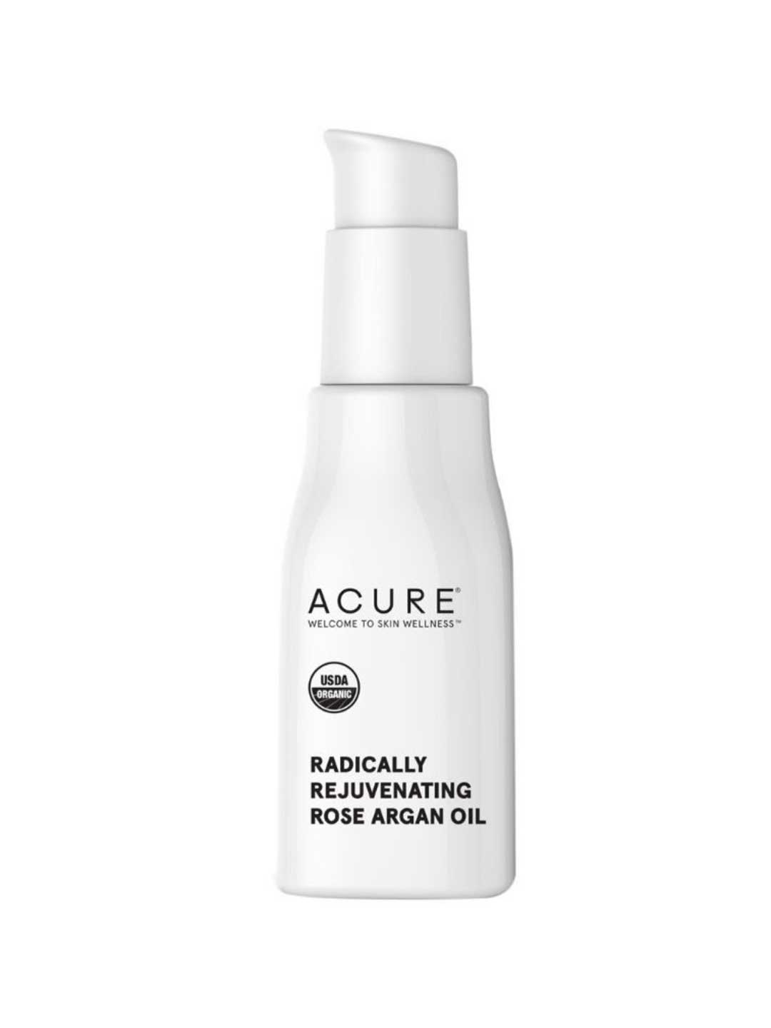 A white pump bottle of Acure Radically Rejuvenating Rose Argan Oil 30ml, featuring a USDA Organic seal, ideal as an organic face oil or versatile hair serum, is shown against a plain background.
