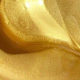 Close-up of a shiny, swirling golden liquid with a smooth texture and glimmering highlights, reminiscent of the luminous appearance of Acure Radically Rejuvenating Under Eye Hydrogels 4g.