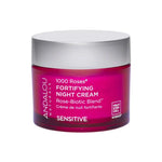 A pink jar of Andalou 1000 Roses Fortifying Night Cream 50g for sensitive skin, featuring alpine rose stem cells and Rose-Biotic Blend, with a white and silver lid shown on a white background.
