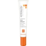 A white tube of Andalou Brightening Luminous Eye Serum 18ml with an orange cap, labeled as a vitamin C brightening eye serum formulated to reduce the appearance of dark circles around the eyes.
