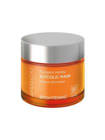 A jar of Andalou Brightening Pumpkin Honey Glycolic Mask 50g featuring a silver lid and orange container, promotes brightening benefits with fruit stem cell science.