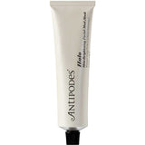 A white tube with a black cap, labeled Antipodes Halo Skin-Brightening Facial Mud Mask 75ml, stands upright against a plain background—ideal for oily, congested skin.