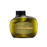 A green, oval bottle of Antipodes Manuka + Orange Volume & Shine Shampoo (340ml) features a black cap and beige label. This natural haircare essential boosts volume and shine with manuka and orange extracts.