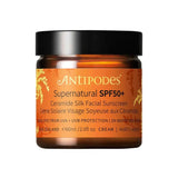 Antipodes Supernatural SPF50+ Ceramide Silk Facial Sunscreen 60ml comes in an amber jar with a black lid and gold and white text, offering broad-spectrum ceramide sunscreen for daily facial protection.