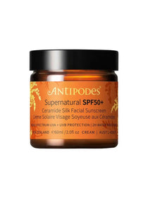 Antipodes Supernatural SPF50+ Ceramide Silk Facial Sunscreen 60ml comes in an amber jar with a black lid and gold and white text, offering broad-spectrum ceramide sunscreen for daily facial protection.
