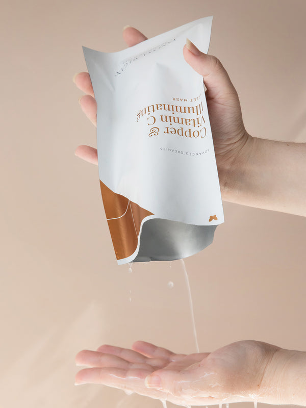 Serum from Vanessa Megan Copper and Vitamin C Sheet Mask poured onto a hand