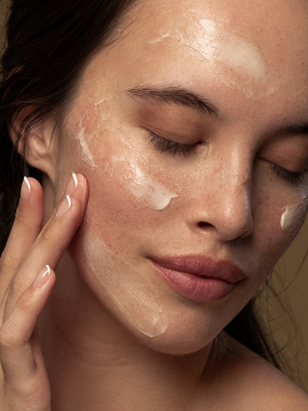 Model applying Antipodes Avocado Pear Collagen-Boosting Night Cream