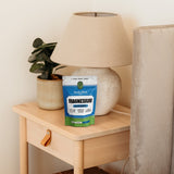 Botanika Blends Magnesium Glycinate beside a bedside table