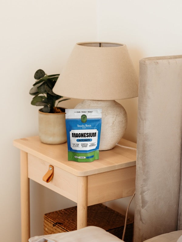 Botanika Blends Magnesium Glycinate beside a bedside table