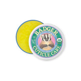 A round tin of Badger Cuticle Care 21g features a badger illustration and USDA Organic seal on the lid. The open tin reveals yellow balm inside, ideal for cuticle care.