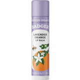 Badger Lip Balm Lavender & Orange 4.2g comes in a purple-capped tube with bee, white flower, and orange illustrations. This certified organic lip balm provides natural moisture and care for your lips.