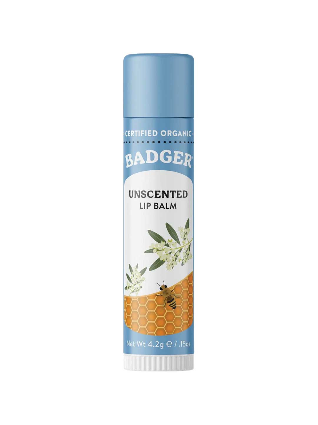 A tube of Badger Lip Balm Unscented 4.2g with a blue cap and label, ideal for sensitive skin. The packaging features olive branches, a honeycomb pattern, a bee, and text: "Certified Organic" and "Net Wt 4.2g / .15oz.