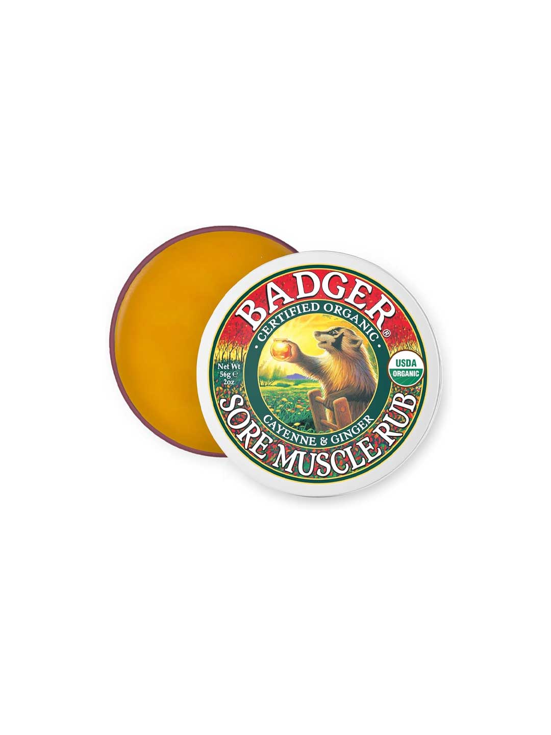 A partially open round tin of Badger Sore Muscle Rub 56g reveals yellow balm. The lid shows a badger illustration and mentions its organic cayenne and ginger heat rub formula for sore muscles.
