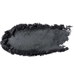 A smear of 100% Pure Fruit Pigmented® Eye Shadow 2g by 100% Pure in black, with rough and uneven edges, appears as a swatch of pigment on a white background.