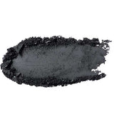 A smear of 100% Pure Fruit Pigmented® Eye Shadow 2g by 100% Pure in black, with rough and uneven edges, appears as a swatch of pigment on a white background.