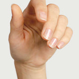 A close-up of a hand with natural, neatly trimmed nails and smooth skin against a plain background highlights nails coated with Sienna Byron Bay Nail Polish - Base Coat for a healthy, polished shine.