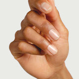 A close-up of a hand with nails painted in Sienna Byron Bay Nail Polish - Base Coat, a plant-derived formula that provides a clear, glossy, and sticky base for a flawless finish.