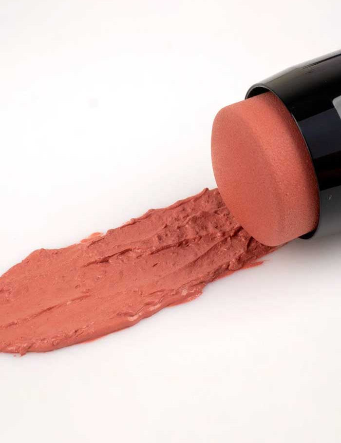 Benecos Multi Stick - Be Rosey lies on its side, its round sponge tip spreading a rosy pink swatch, ideal as a 3-in-1 natural makeup for lips, cheeks, and eyes.