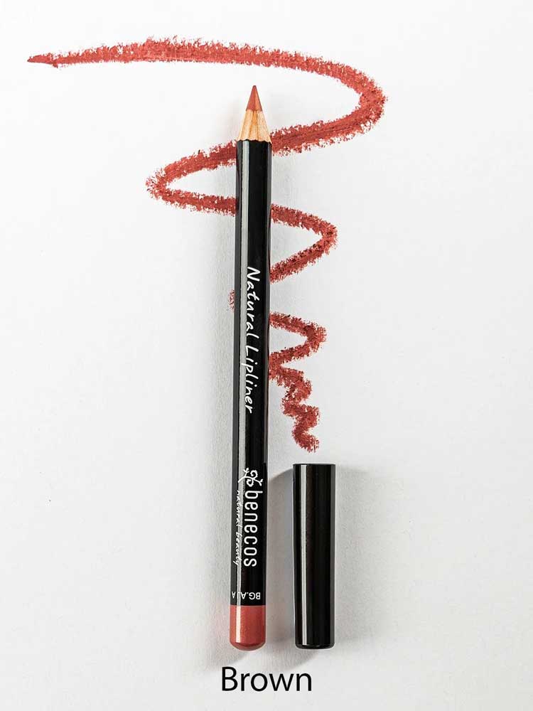 A Benecos Natural Lipliners 1.13g pencil, cap removed, rests on a white surface with a wavy brown line above it highlighting its rich color. The word "Brown" appears below.