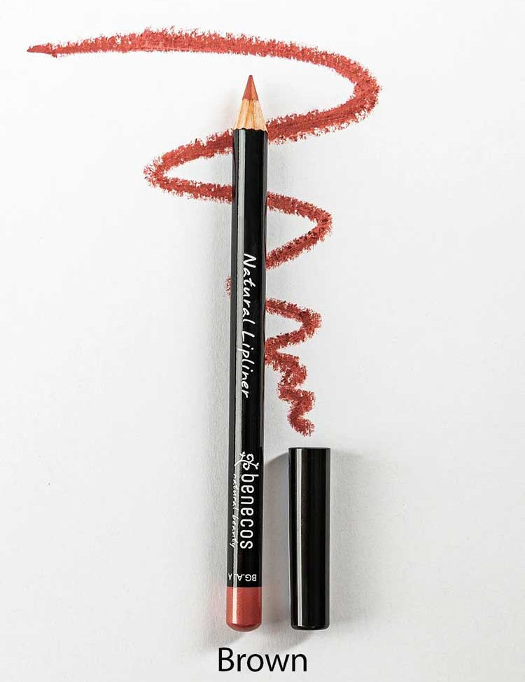 A Benecos Natural Lipliners 1.13g pencil, cap removed, rests on a white surface with a wavy brown line above it highlighting its rich color. The word "Brown" appears below.