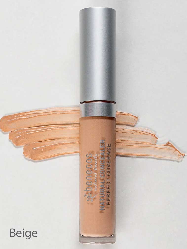 A tube of Benecos Concealer 5ml with a silver cap is placed on a light background. Beige concealer swatches are spread behind the tube, and "Beige" appears in the lower left corner. The formula is vegan and long-lasting.