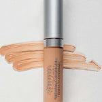 A tube of Benecos Concealer 5ml with a silver cap is placed on a light background. Beige concealer swatches are spread behind the tube, and "Beige" appears in the lower left corner. The formula is vegan and long-lasting.