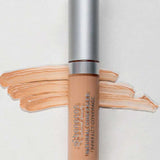 A tube of Benecos Concealer 5ml with a silver cap is placed on a light background. Beige concealer swatches are spread behind the tube, and "Beige" appears in the lower left corner. The formula is vegan and long-lasting.