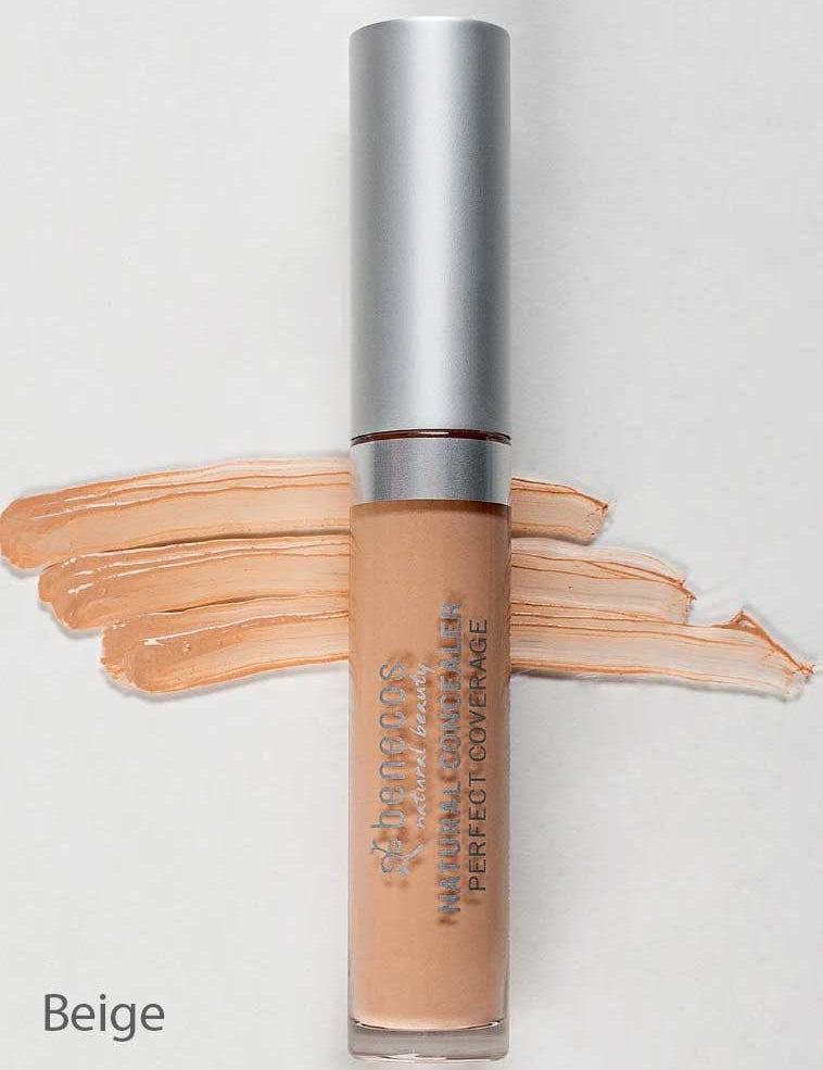 A tube of Benecos Concealer 5ml with a silver cap is placed on a light background. Beige concealer swatches are spread behind the tube, and "Beige" appears in the lower left corner. The formula is vegan and long-lasting.