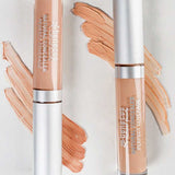 Two tubes of Benecos Concealer 5ml stand upright on a white background, with swatches of this long-lasting formula in various shades displayed beside each tube.